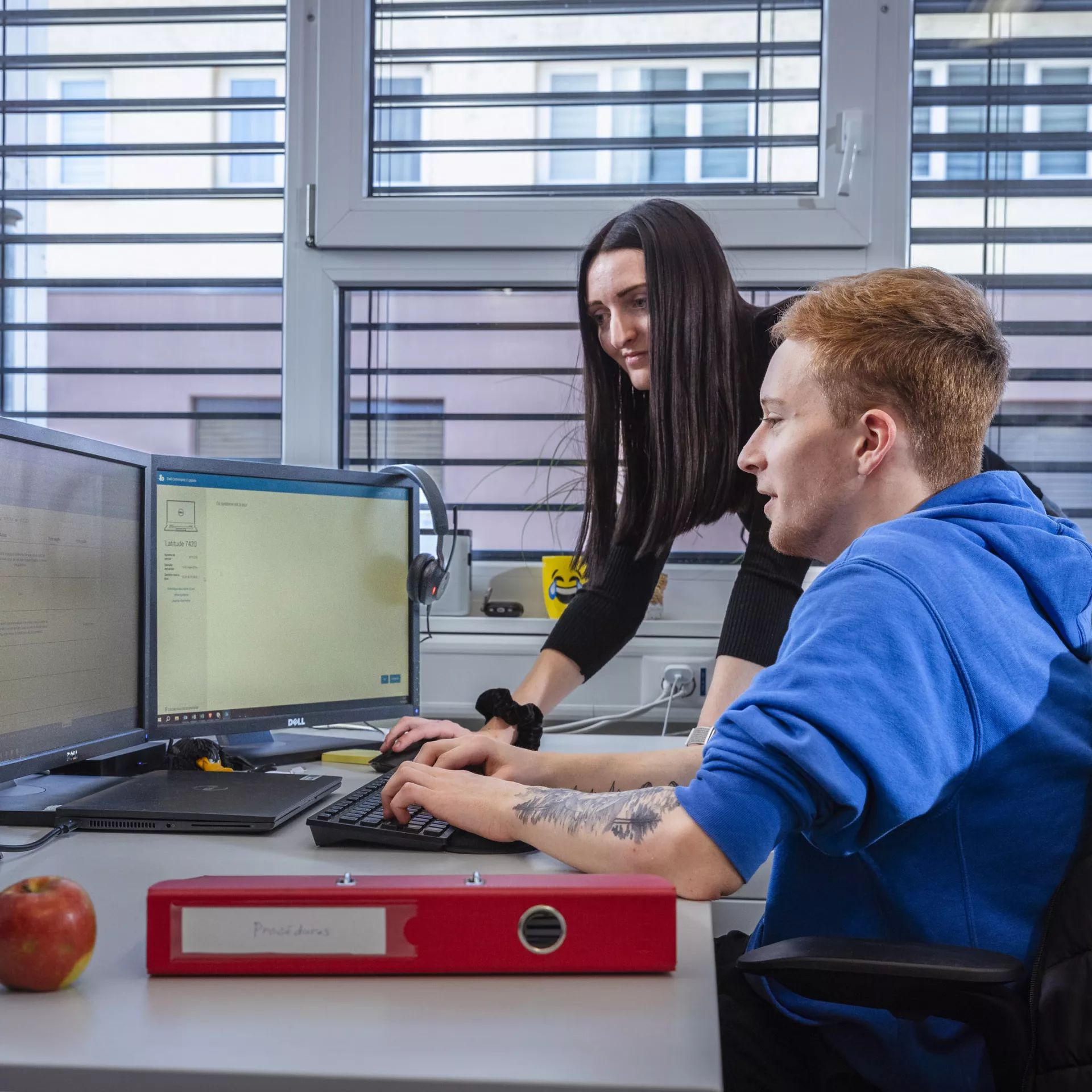 Personne qui montre des travaux sur un ordinateur à une autre personne